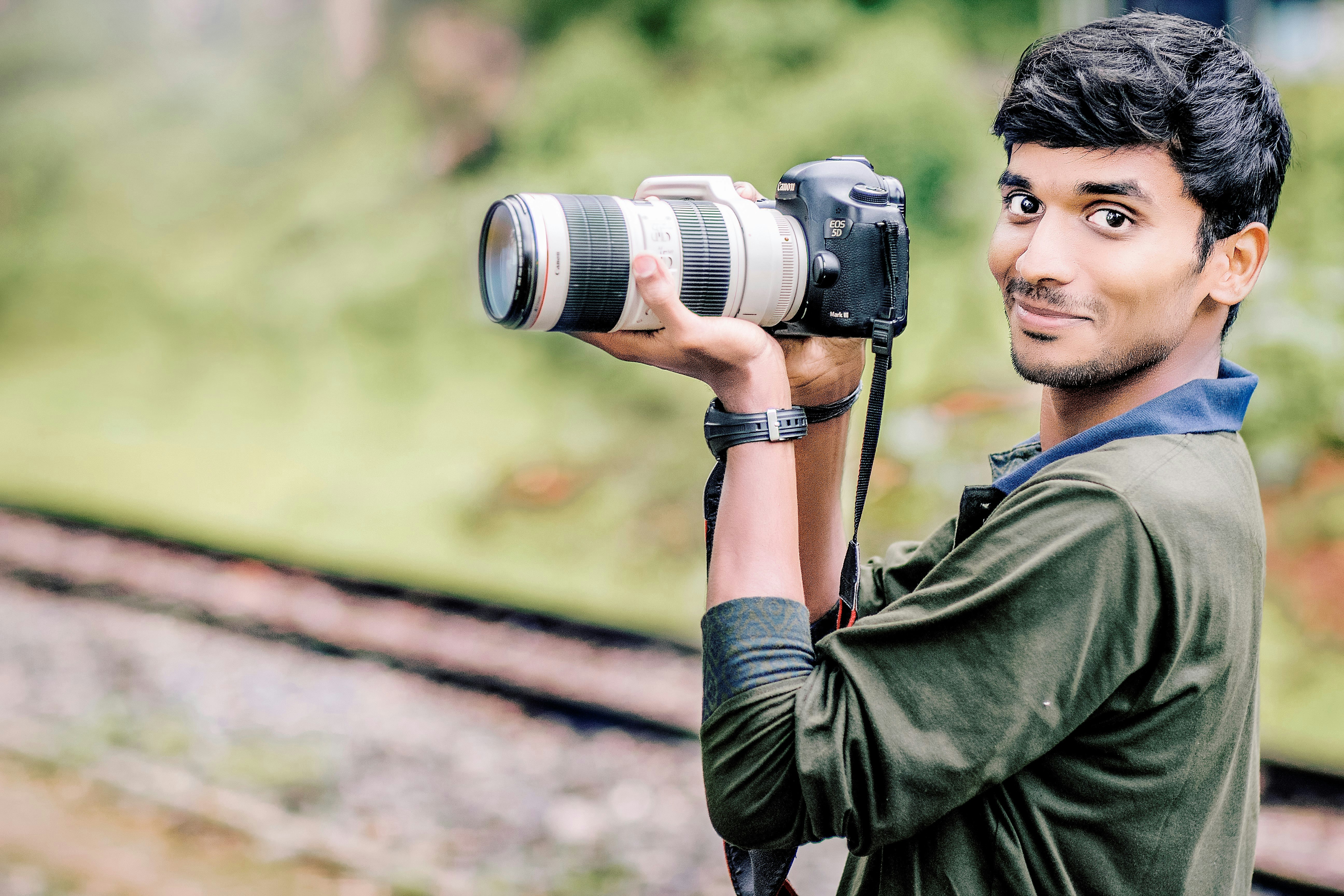 man taking photo in selective focus photography